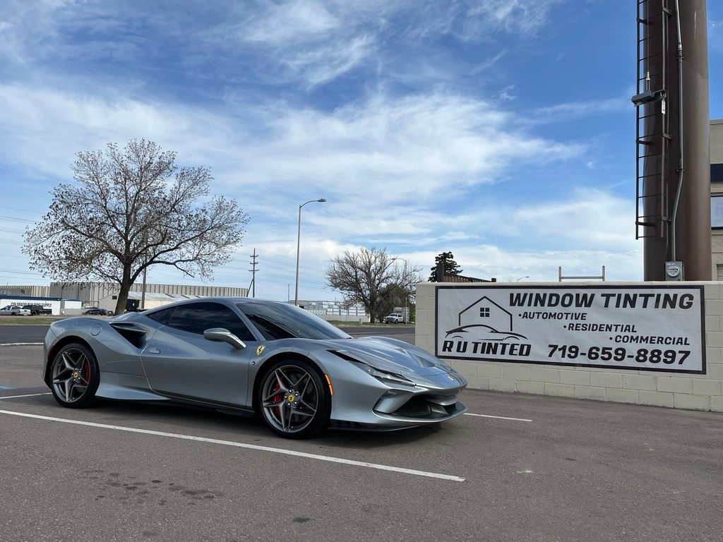 Silver Ferrari beside the R U Tinted sign