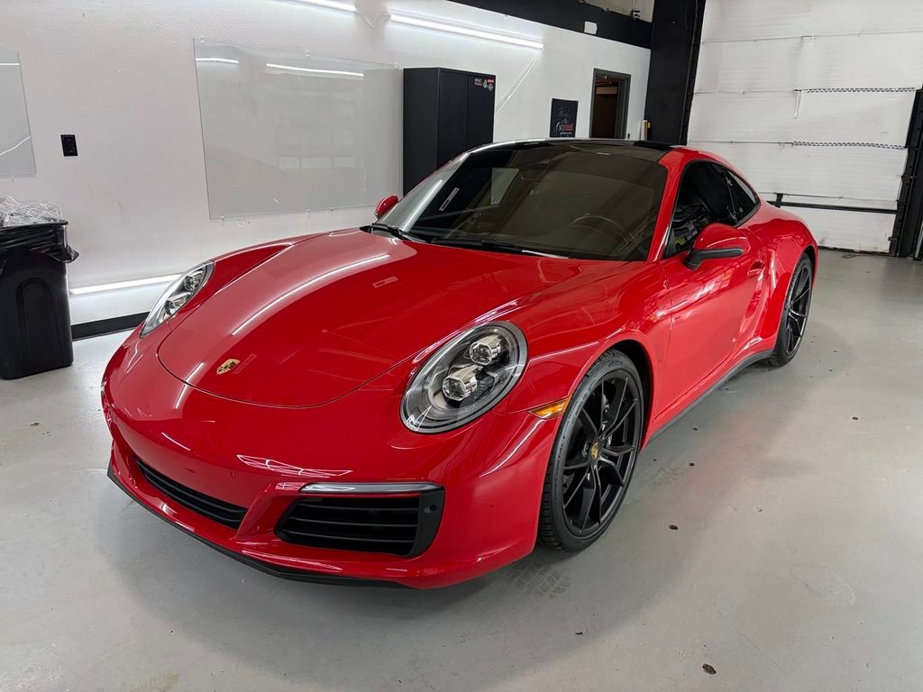 Red Porsche in the R U Tinted installation bay