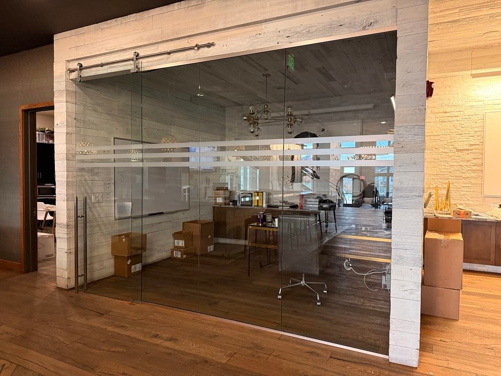Glass office partition with decorative privacy stripes
